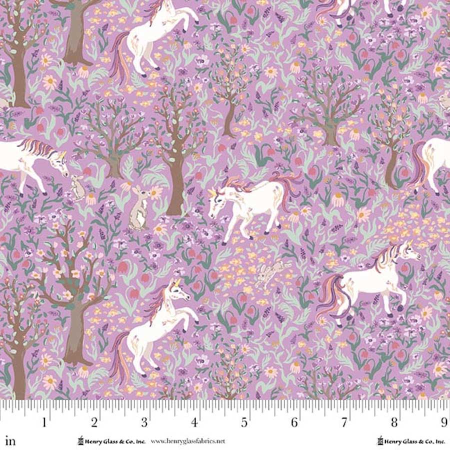 White unicorns in a forest on a purple background fabric from Henry Glass Fabrics.